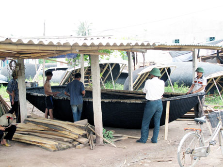 Những người thợ ở làng nghề Hưng Học đang thực hiện công đoạn cuối để hoàn thiện một chiếc thuyền nan.