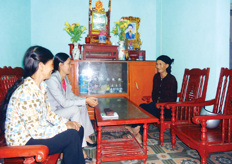 Bà con hàng xóm cùng chia vui với bà Lê Thị Lén (bên phải) trong ngôi nhà “Đại đoàn kết” được xây tặng.