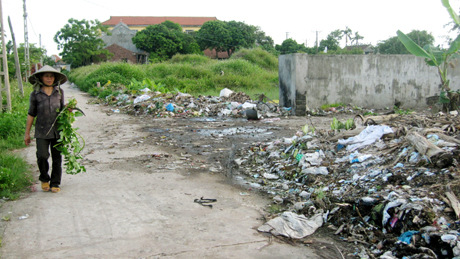 Rác thải được tập kết ngay cạnh đường dân sinh, gây mất vệ sinh môi trường. (Ảnh chụp tại Cẩm La, TX Quảng Yên).