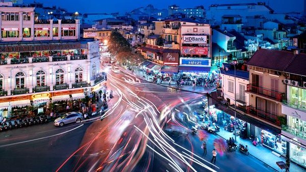 Hanoi is very beautiful when you sit behind a motorcycle, the major means  of transportation of people here, to travel small streets here. Looking from above,  motorcycles, cars, and cyclos on the intersection of Dinh Tien Hoang and  Hang Dao create beautiful light rivers.