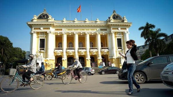 Hanoi is very beautiful when you sit behind a motorcycle, the major means  of transportation of people here, to travel small streets here. Looking from above,  motorcycles, cars, and cyclos on the intersection of Dinh Tien Hoang and  Hang Dao create beautiful light rivers.