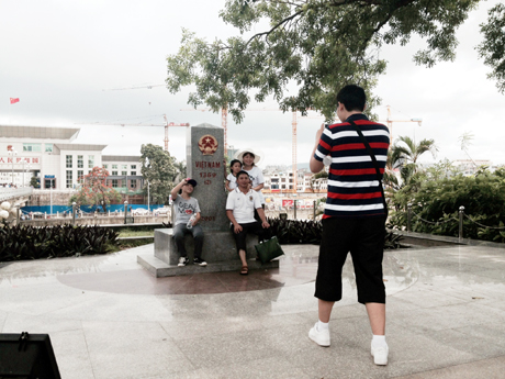 Du khách chụp ảnh lưu niệm tại cột mốc 1369 (2) tại Cửa khẩu Quốc tế Móng Cái.