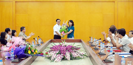 Đồng chí Vũ Thị Thu Thủy, Phó Chủ tịch UBND tỉnh tặng hoa chúc mừng đồng chí Nguyễn Thành Nam, Phó Giám đốc Kho bạc Nhà nước tỉnh.