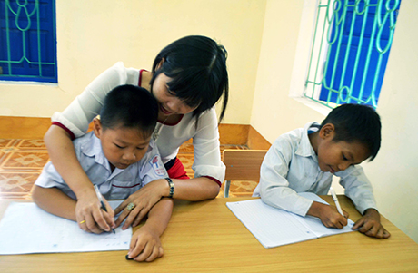 Cô giáo Đinh Thị Hồng Tỉnh hướng dẫn học sinh làm bài.