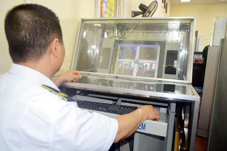 Cán bộ Trung tâm kiểm dịch y tế quốc tế kiểm tra thân nhiệt qua hệ thống máy đo tại cửa khẩu Móng Cái.