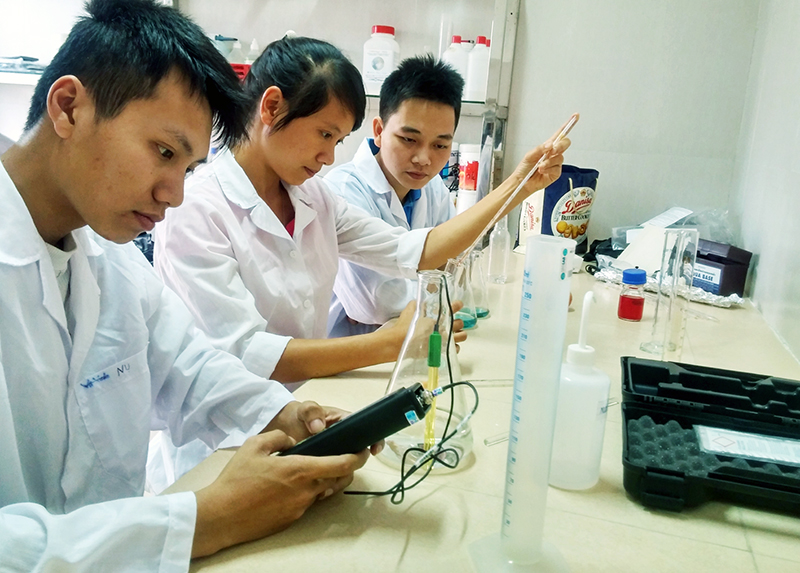 Kỹ sư của Công ty CP Thực phẩm Bim, kiểm tra chất lượng môi trường nước ương tôm bằng phương pháp hoá học trong phòng thí nghiệm.