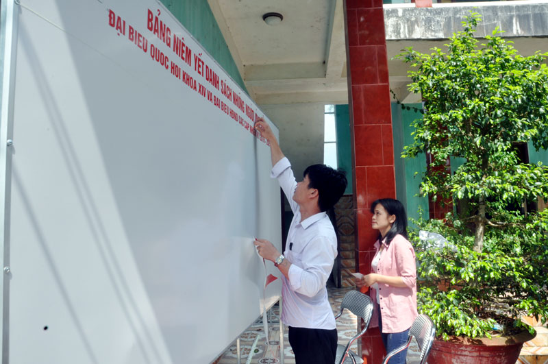 Cán bộ xã Quảng Đức (Hải Hà) niêm yết danh sách những người ứng cử đại biểu HĐND xã, nhiệm kỳ 2016-2021 tại trụ sở UBND xã.
