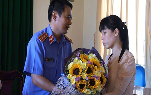Bà Ngọc nhận hoa xin lỗi của đại diện VKSND huyện Nhơn Trạch.