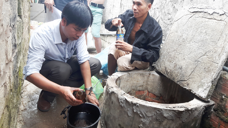 Lực lượng chức năng lấy mẫu nước để phân tích, quan trắc