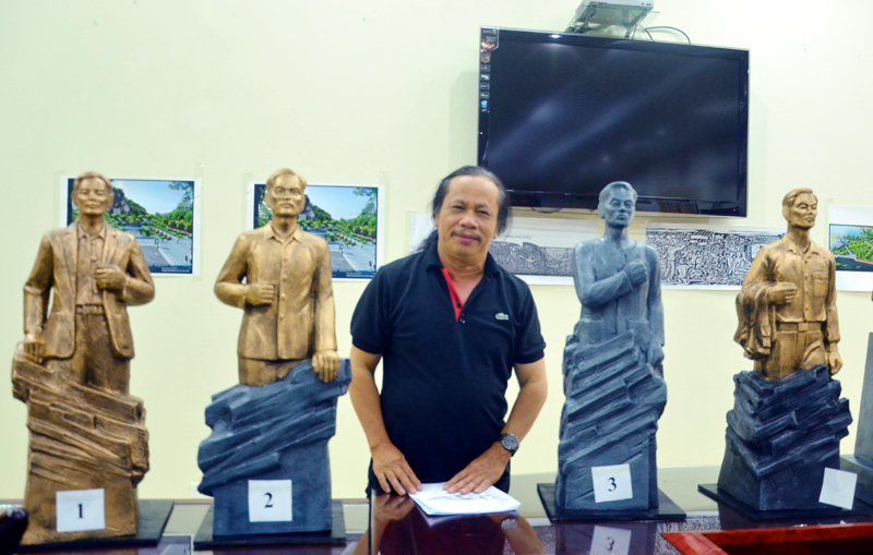 Nhà điêu khắc Phạm Sinh bên một số phác thảo mẫu tượng đài đồng chí Vũ Văn Hiếu. 