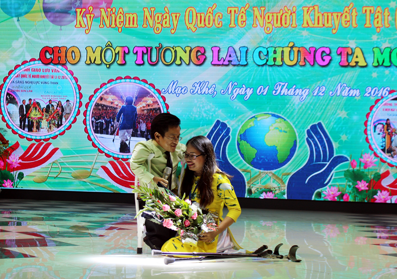 Chị Nguyễn Hải Yến, Chủ nhiệm CLB Người khuyết tật TX Đông Triều tặng hoa diễn giả Nguyễn Sơn Lâm.