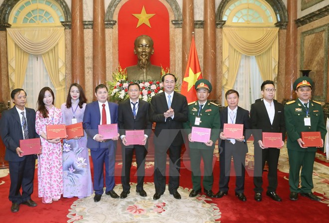 Chủ tịch nước Trần Đại Quang tặng quà cho các đại biểu tại buổi gặp mặt. (Ảnh: Nhan Sáng/TTXVN)