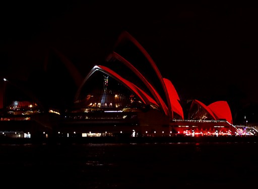 Nhà hát Opera tại Sydney, Australia được chiếu sáng màu đỏ trong đêm giao thừa. (Ảnh: AFP)