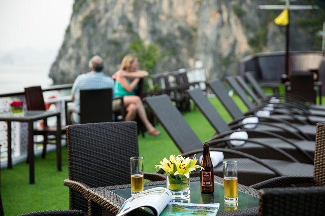 Tourists can sit on the sundeck of the Paloma Cruise and enjoy a glass of wine or cocktail for panoramic views of Ha Long Bay.Visitors can sit on the sundeck of Paloma Cruise and enjoy a glass of wine or cocktail for panoramic views of Halong Bay.