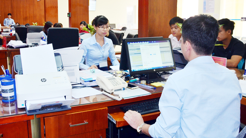 Cán bộ Trung tâm Hành chính công TP Cẩm Phả xử lý các thủ tục hành chính gửi qua mạng ở mức độ 3 trên hệ thống máy tính.