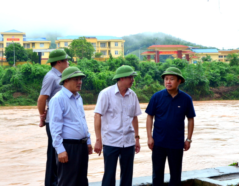 Đồng chí Nguyễn Đức Thành, Phó Chủ tịch HĐND tỉnh nghe các đồng chí lãnh đạo huyện Ba Chẽ báo cáo tình hình mưa lũ trong ngày 7/10 tại địa điểm ngập nặng nhất là tầng 1 khu chợ Ba Chẽ