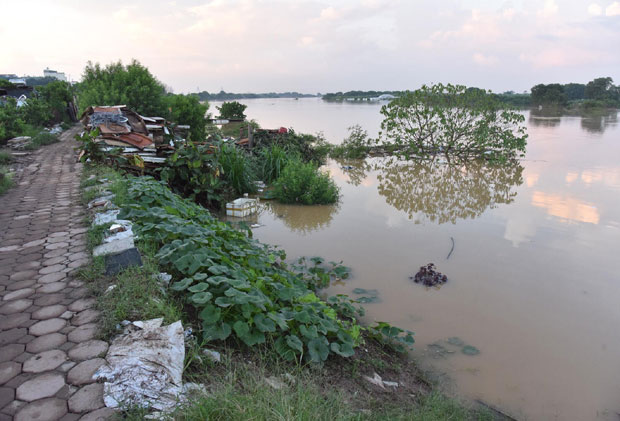 Mực nước lũ dâng cao nhanh trong đêm tràn vào các khu vực canh tác của người dân hai bên bờ sông Hồng.