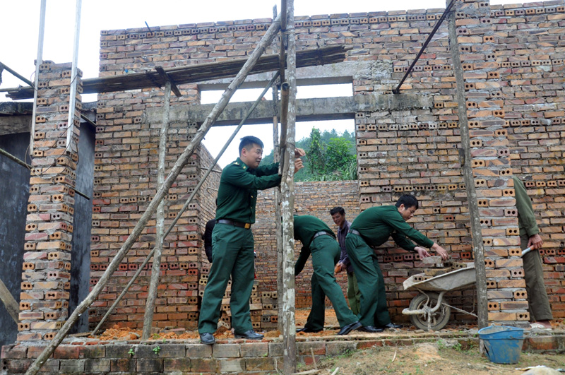 Cán bộ, chiến sĩ Đồn Biên phòng cửa khẩu Hoành Mô giúp gia đình ông Tằng Vằn Làu ở bản Phật Chỉ vận chuyển vật liệu xây dựng chuẩn bị xây nhà