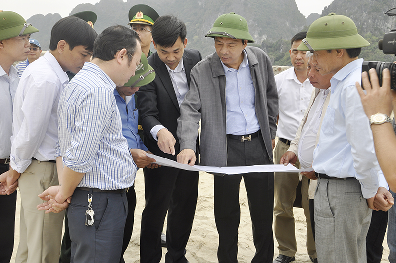 Đồng chí  Nguyễn Văn Đọc kiểm tra dự án qua sơ đồ thiết kế.