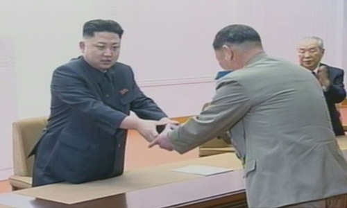 Lãnh đạo Triều Tiên Kim Jong-un trao cho nhà khoa học vũ khí hạt nhân một chiếc đồng hồ có in tên cố lãnh đạo Kim Jong-il để ghi nhận sự đóng góp của ông đối với an ninh quốc gia vào tháng 2/2013. Ảnh: Korea Times.