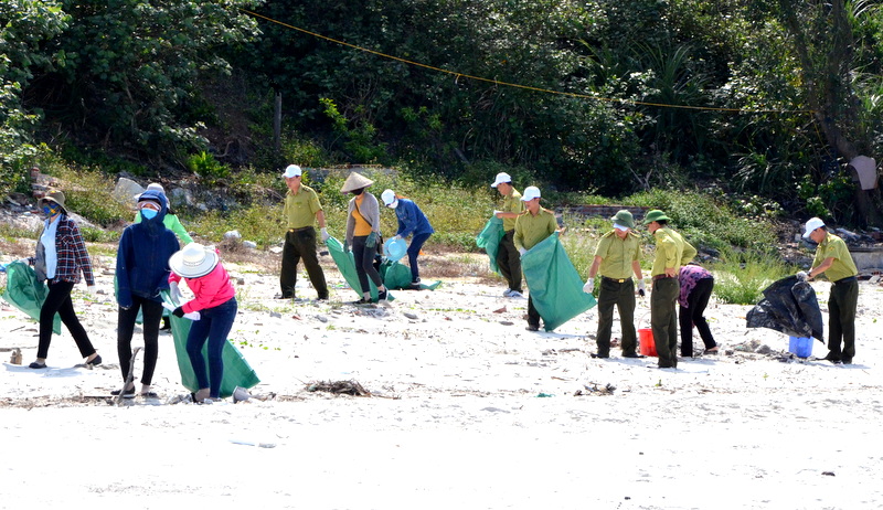 Người dân cùng Ban quản lý Vường quốc gia Bái Tử Long tham gia hoạt động làm sạch biển tại đảo Minh Châu hưởng ứng Tuần lễ biển và hải đảo. ( Ảnh Lương Giang)