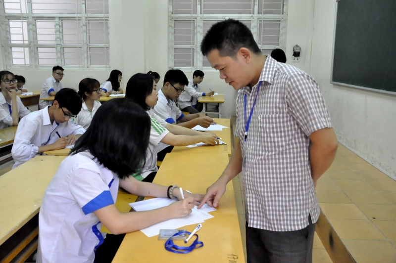 Cán bộ coi thi kiểm tra thẻ dự thi thí sinh tại điểm thi THPT Hòn Gai, TP Hạ Long