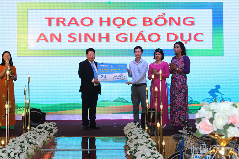 Ông Nguyễn Thế Anh – Giám đốc công ty Bảo Việt Nhân thọ Uông Bí (đứng bên trái) trao biển tài trợ cho ông Nguyễn Phúc Phong – Giám đốc Quỹ Bảo trợ trẻ em Quảng Ninh (đứng thứ 3 từ phải sang)