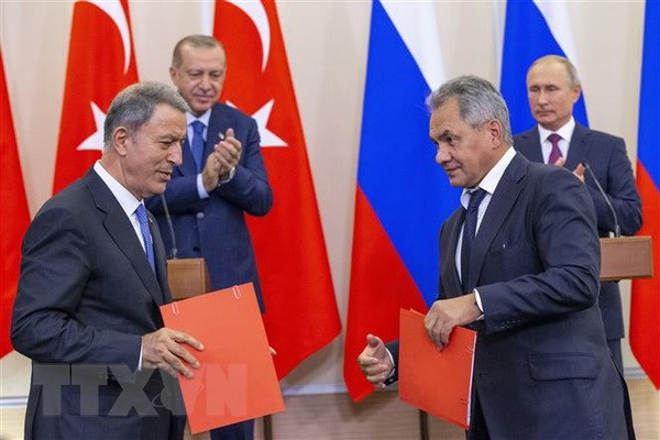 Tổng thống Nga Vladimir Putin (phải, phía sau) và người đồng cấp Thổ Nhĩ Kỳ Recep Tayyip Erdogan (trái, phía sau) chứng kiến lễ trao đổi thỏa thuận về Syria giữa Bộ trưởng Quốc phòng Nga Sergei Shoigu (phải, phía trước) và người đồng nhiệm Thổ Nhĩ Kỳ Hulusi Akar (trái, phía trước) tại Sochi (Nga) ngày 17/9. (Ảnh: AFP/TTXVN)
