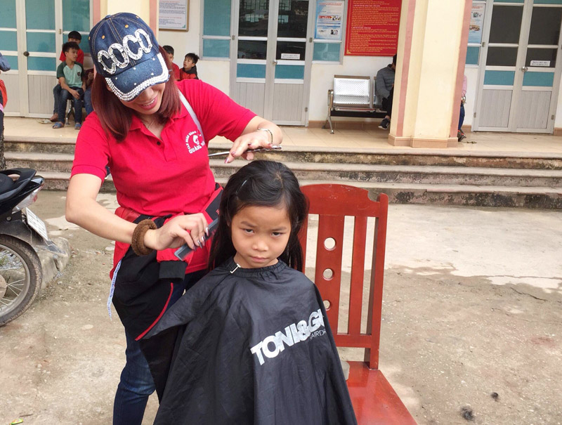 Các thành viên trong Đoàn tình nguyện tổ chức cắt tóc cho trẻ em xã Kỳ Thượng, huyện Hoành Bồ.