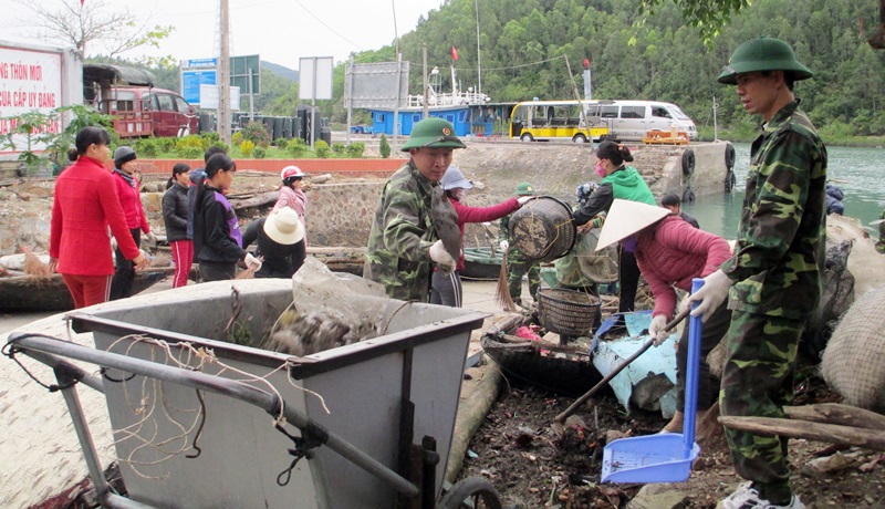 Các chiến sĩ Đồn Biên phòng Ngọc Vừng cùng nhân dân dọn vệ sinh môi trường tại khu vực cảng tàu thôn Ngọc Nam, xã Ngọc Vừng. 