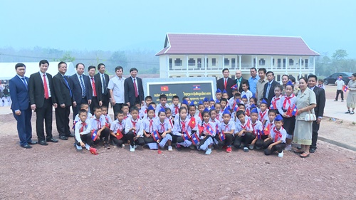 Đoàn công tác tỉnh Quảng Ninh và tỉnh Luông Pha Băng cùng thầy và trò Trường Tiểu học Hữu nghị Luông Pha Băng- Quảng Ninh chụp ảnh kỷ niệm trước ngôi trường mới. 