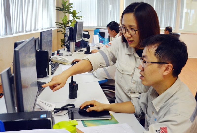 Kỹ sư Lương Thị Minh Hưng, thành viên của nhóm sáng kiến Bộ phận Lò nghiền Than- Công ty CP Xi măng Thăng Long cùng đồng nghiệp kiểm tra hệ thống lò nghiền nung tại bộ phận điều hành hoạt động sản xuất. 