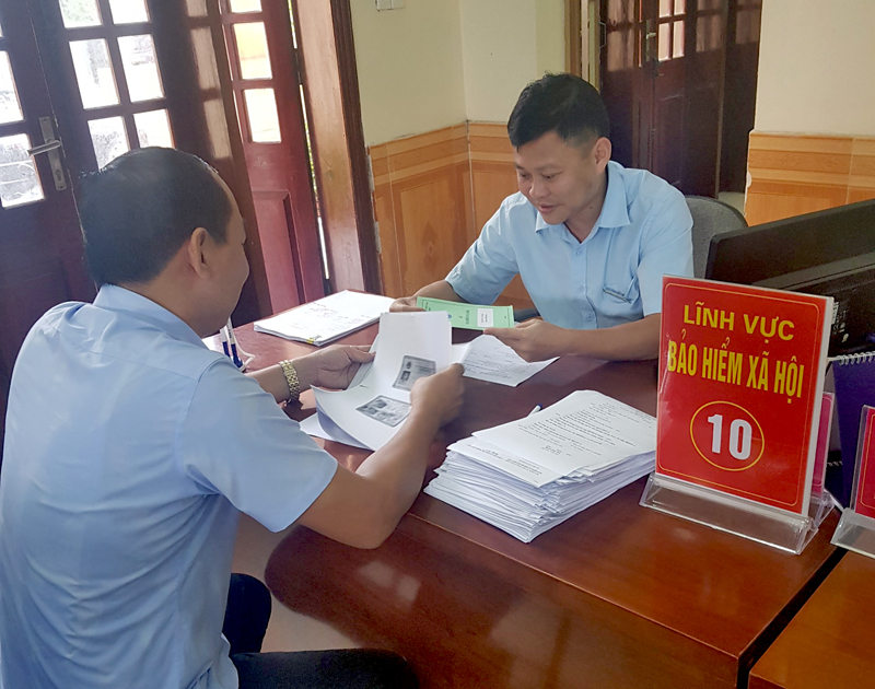 Cán bộ BHXH huyện Tiên Yên làm thủ tục BHYT cho người dân tại Trung tâm Hành chính công huyện.