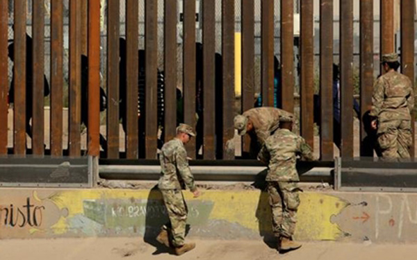 Lính Mỹ tại hàng rào ở biên giới với Mexico tại El Paso, Texas ngày 3/4. (Ảnh: Reuters).