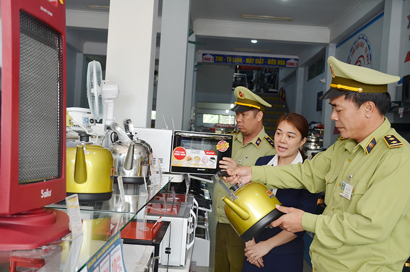 Đội QLTT số 12 huyện Đầm Hà kiểm tra nguồn gốc xuất xứ hàng hóa tại một cửa hàng điện tử trên địa bàn.