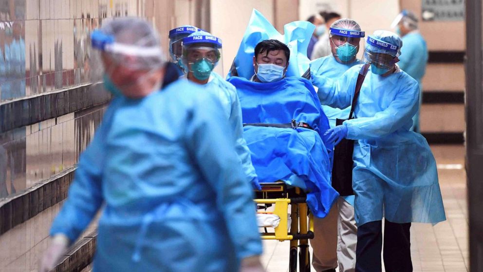 Nhân viên y tế tại bệnh viện Queen Elizabeth (Hong Kong, Trung Quốc) đưa bệnh nhân nghi nghiễm virus Corona nhập viện theo dõi. Ảnh: Reuters