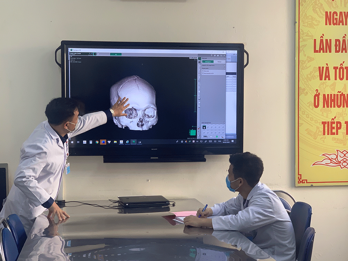 Bác sĩ Lương Kịm Toàn, Trưởng khoa Chấn thương Chỉnh hình, Bệnh viện Đa khoa tỉnh Quảng Ninh (bên trái) kiểm tra chấn thương của anh Triệu Kịm Tịnh trên hệ thống máy tính