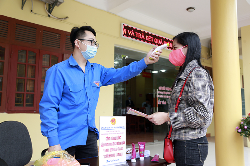 ĐVTN thị trấn Tiên Yên thực hiện đo thân nhiệt và phát khẩu trang, tờ rơi miễn phí cho công dân đến làm việc tại bộ phận một cửa
