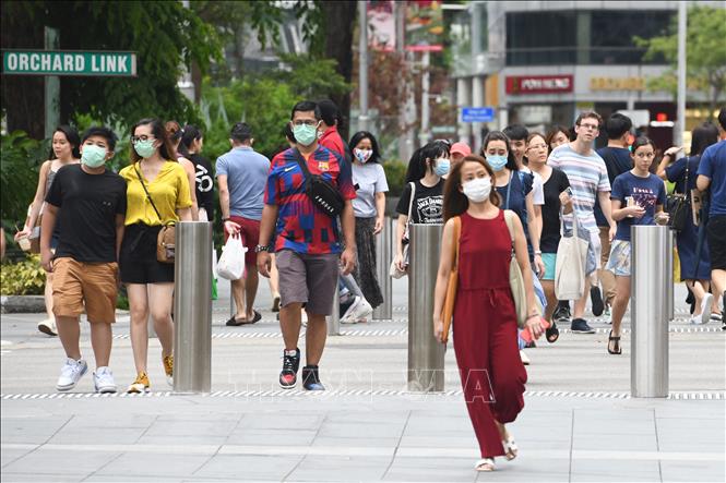 Người dân đeo khẩu trang nhằm ngăn chặn sự lây lan của dịch COVID-19 tại Singapore ngày 5/4/2020. Ảnh: AFP/TTXVN