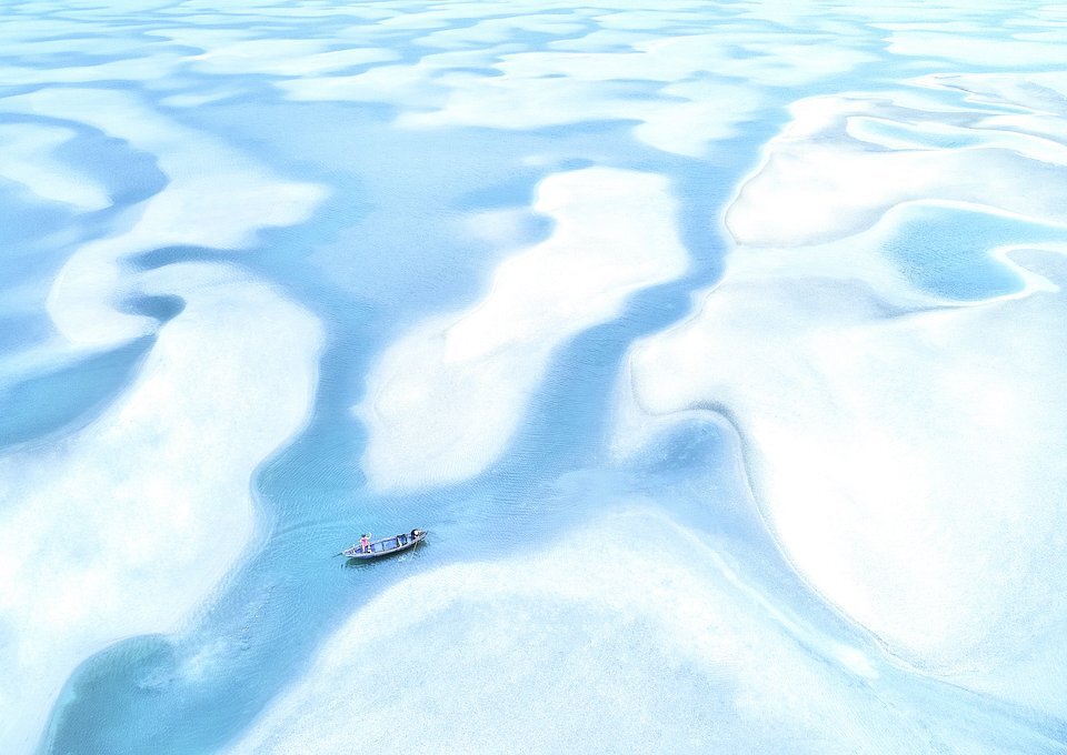 Ảnh “Ngày triều xuống” của Phạm Huy Trung được chụp tại đầm Lập An, Huế. Theo tác giả, khi triều rút hết, bạn có thể thấy rõ lớp cát trắng nằm dưới mặt nước, nhờ đó mà bức ảnh của anh đẹp như tranh vẽ.