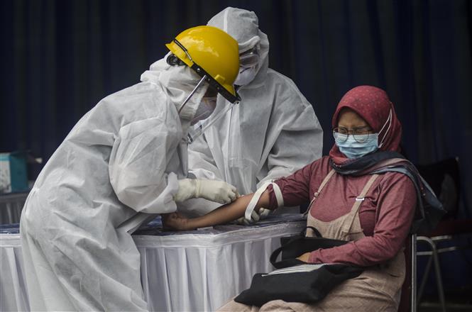 Nhân viên y tế lấy mẫu xét nghiệm Covid-19 cho người dân tại tỉnh Tây Java, Indonesia ngày 4/4/2020. Ảnh: THX/TTXVN