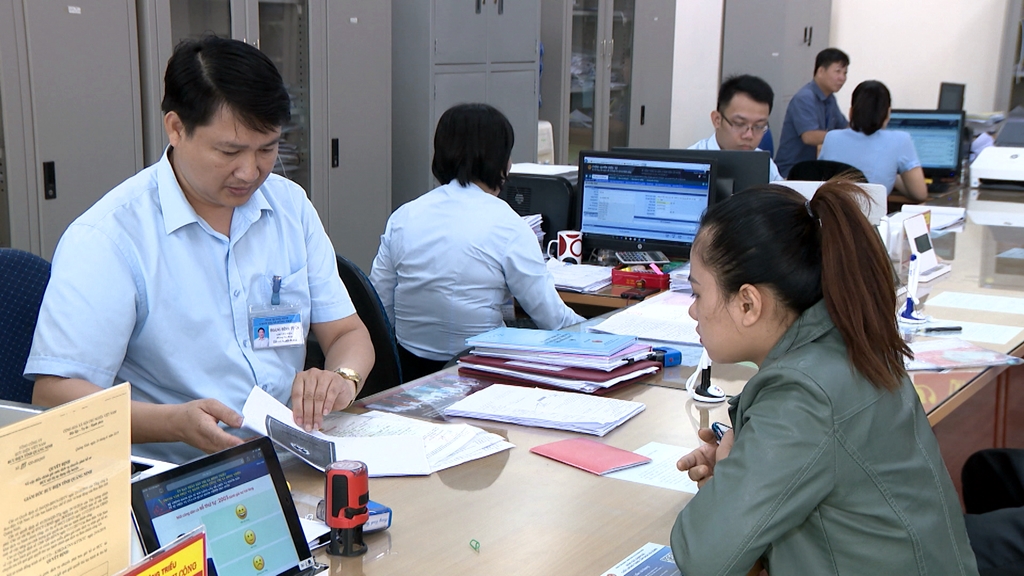  Cán bộ Trung tâm Hành chính công TX Quảng Yên hướng dẫn người dân thực hiện quy trình đăng ký giải quyết TTHC. Ảnh: Minh Hà