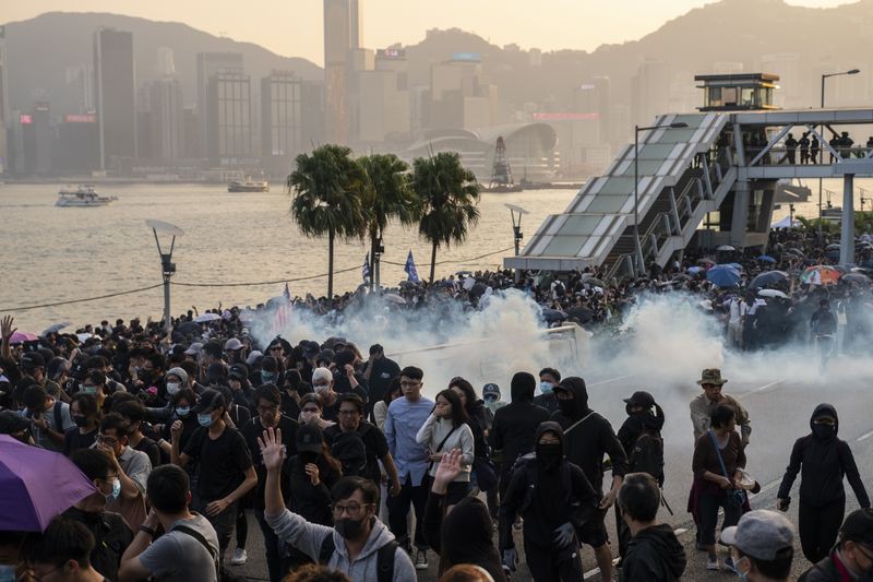 Cảnh sát Hong Kong xịt hơi cay, giải tán người biểu tình tháng 12/2019. Ảnh: Bloomberg.