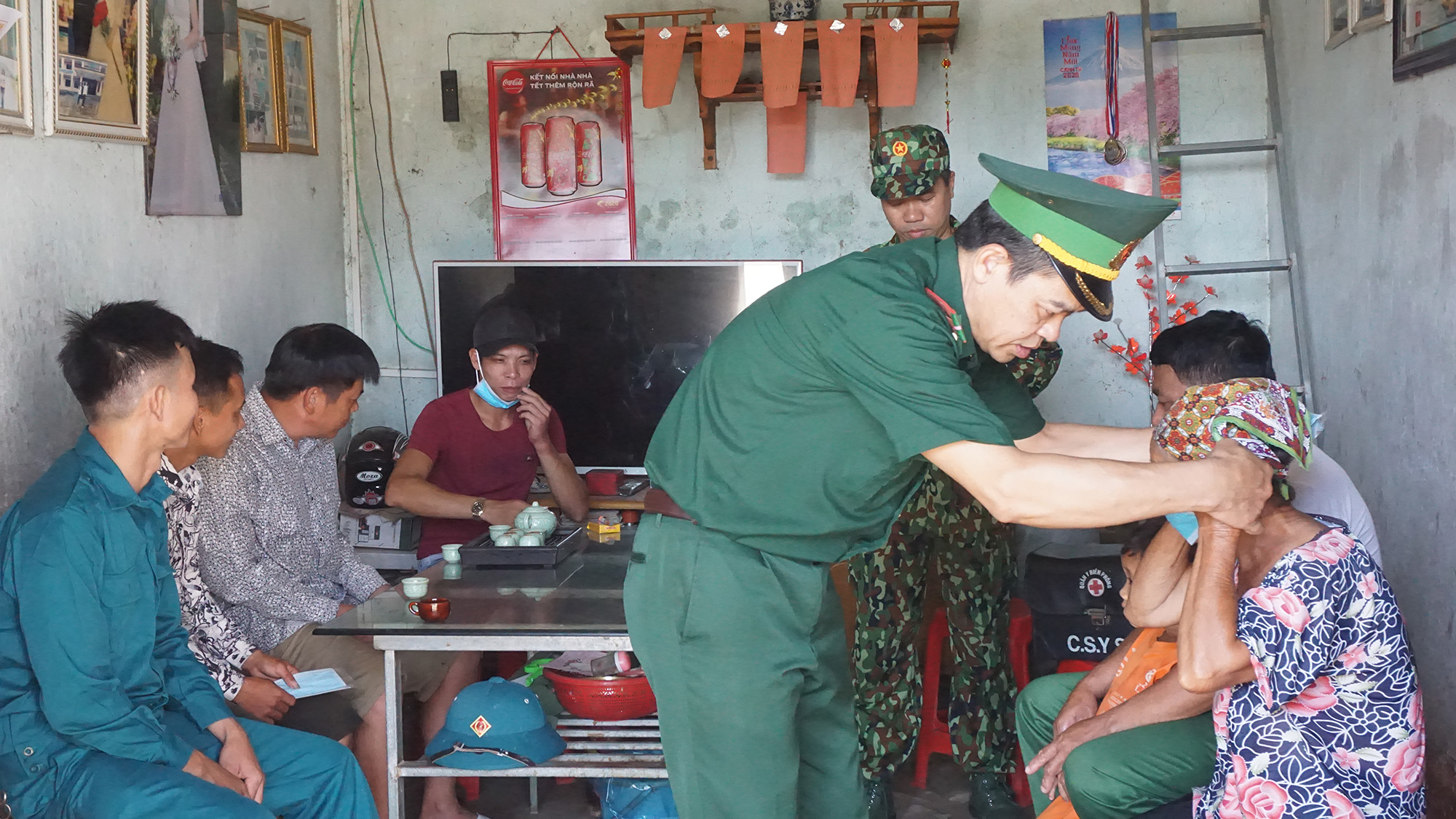 Cán bộ Đồn Biên phòng Quảng Đức và lực lượng dân quân địa phương tuyên truyền phòng, chống dịch bệnh, phát khẩu trang cho người dân bản Mốc 13, xã Quảng Đức (huyện Hải Hà).