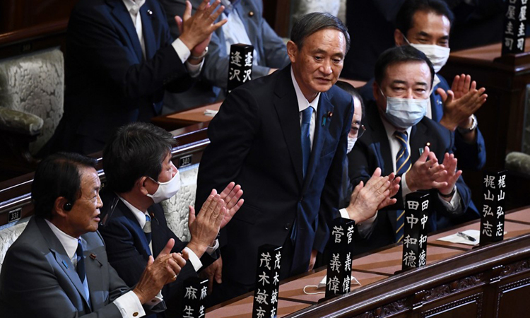 Ông Yoshihide Suga (giữa) được vỗ tay hoan nghênh sau khi kết quả kiểm phiếu tại quốc hội hôm nay cho thấy ông trở thành thủ tướng Nhật. Ảnh: AFP.