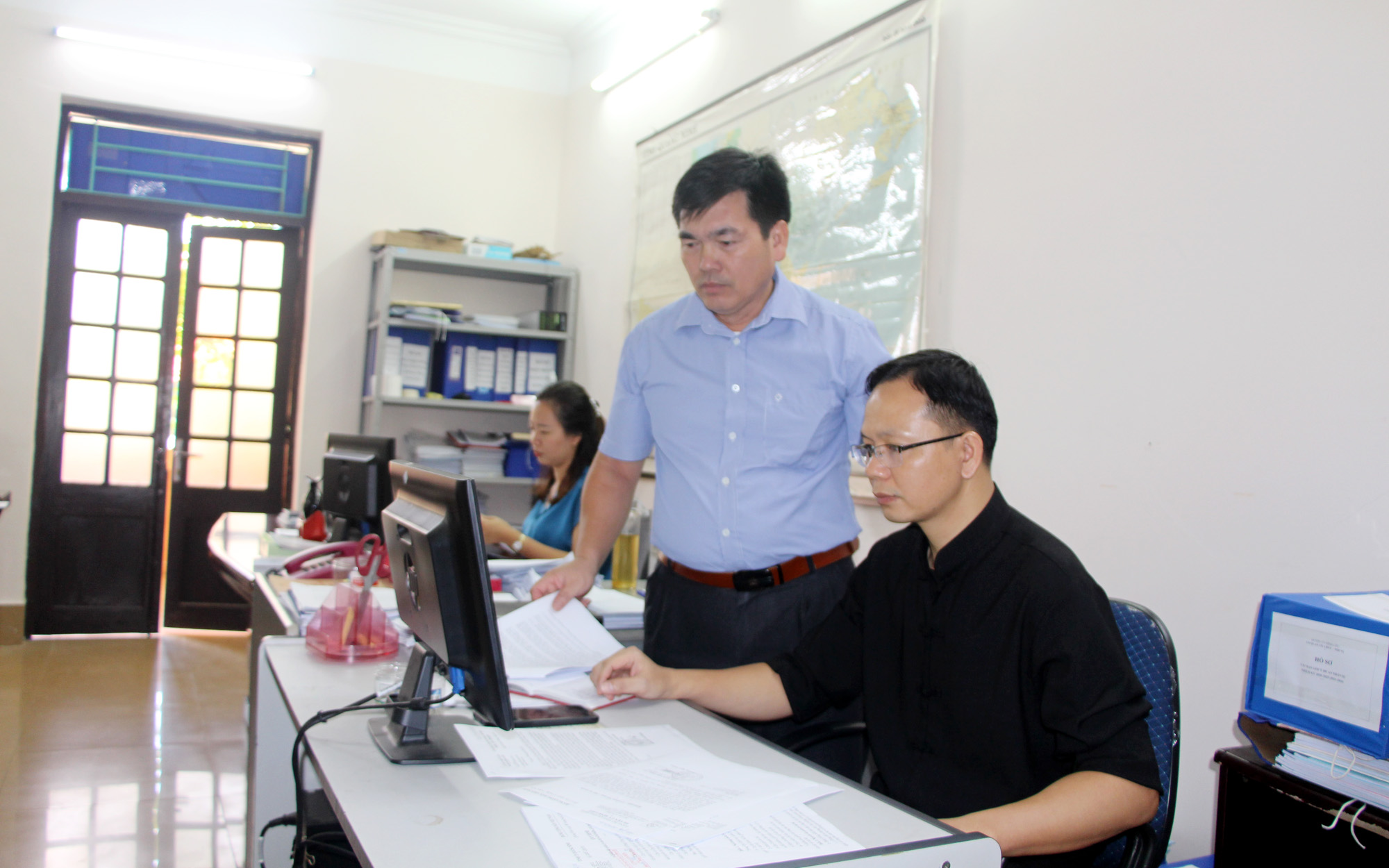 Thủ trưởng Cơ quan Tổ chức Nội vụ huyện Bình Liêu trao đổi công việc với CBCC của cơ quan.