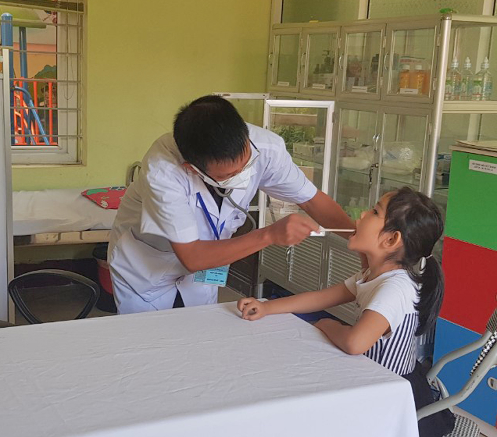 Nhân viên y tế Trường mầm non thị trấn Quảng Hà (Hải Hà) kiểm tra sức khỏe về răng cho trẻ mầm non tại Trường.