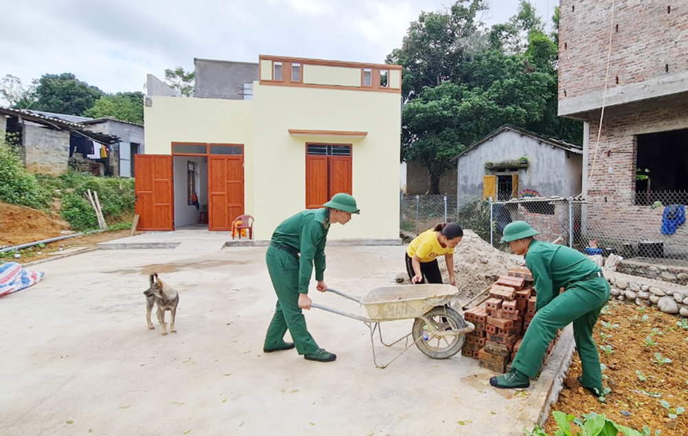  Chiến sĩ Đồn BPCK Hoành Mô giúp gia đình chị Hoàng Thị Cam (thôn Đồng Cậm, xã Hoành Mô, huyện Bình Liêu) hoàn thiện khâu cuối cùng để chuyển vào nhà mới.