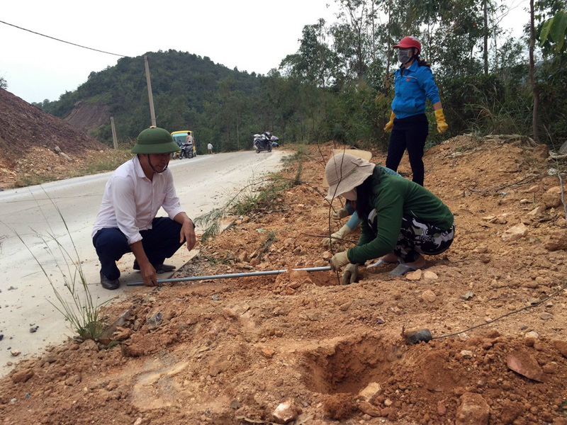 Cán bộ và nhân dân xã Cái Chiên trồng cây xanh hai bên đường trục xã.