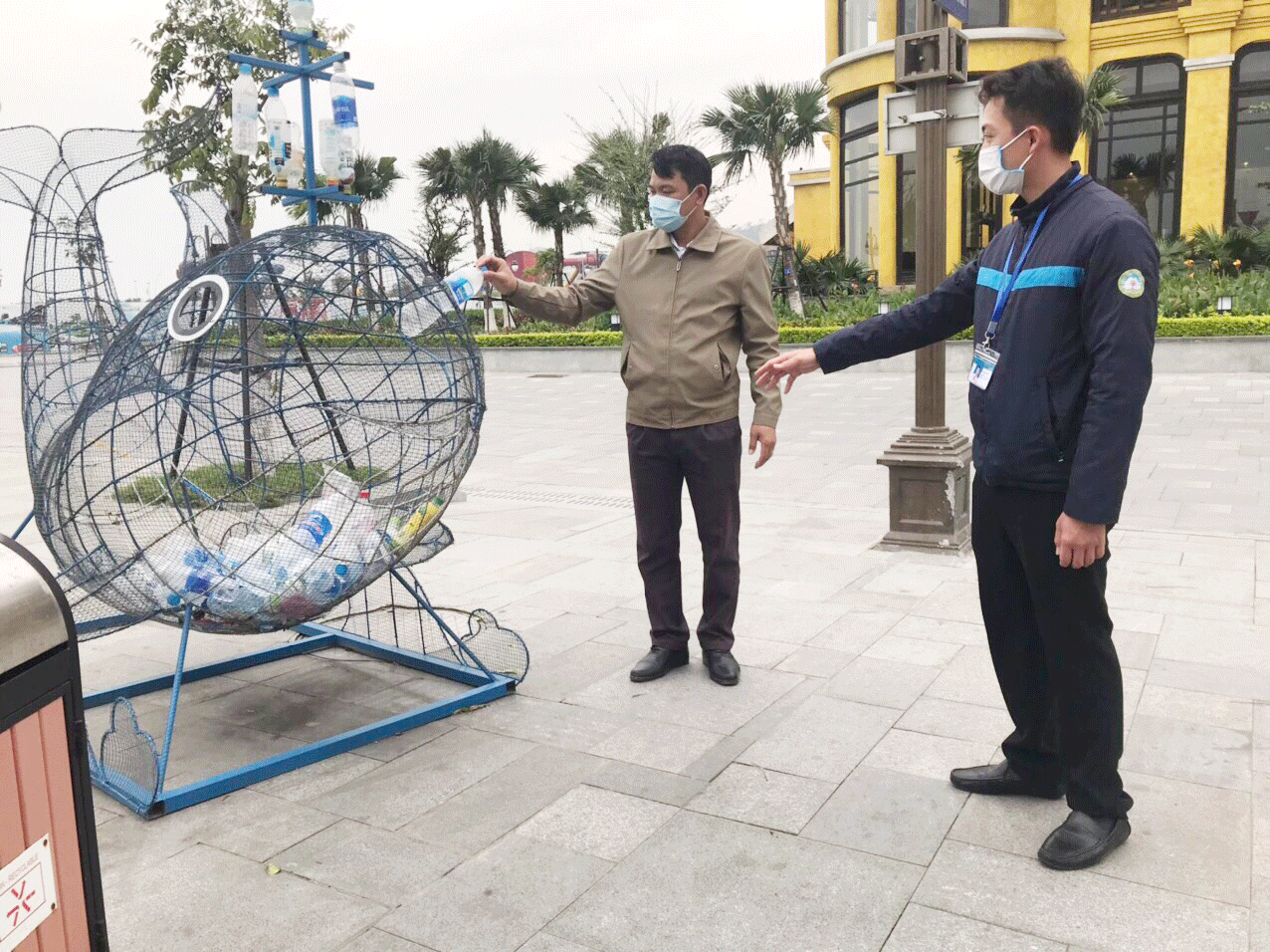 Nhân viên Ban quản lý Vịnh Hạ Long hướng dẫn du khách tham quan thả vỏ chai vào chú cá đựng rác thải nhựa tại khu vực Cảng tàu khách quốc tế Hạ Long.